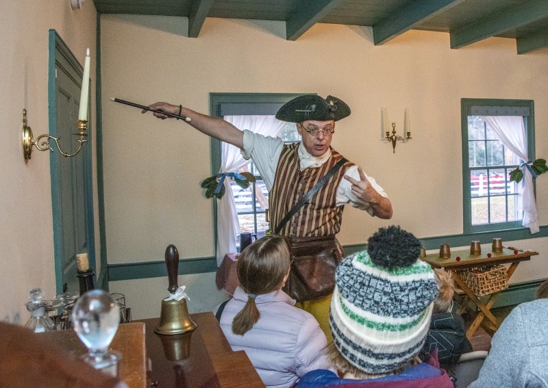 Peter Gardiner, the 18th-century conjuror at the Historic Lewes Shipcarpenter Square Campus, tempts guests with magic.